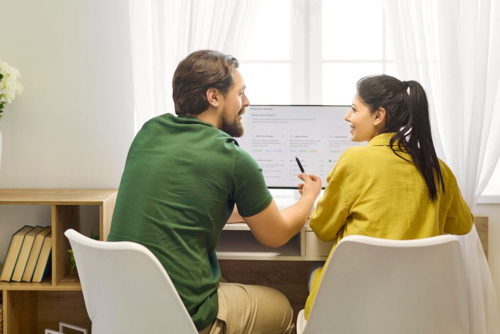 Smiling couple reviewing budget at home