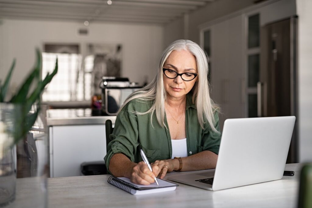 Senior fashionable woman working at home